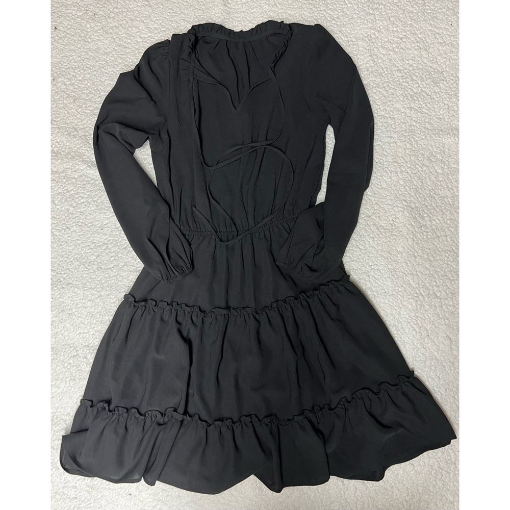 A cute black dress with slight ruffles.